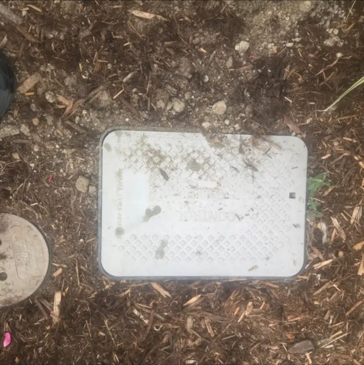 Valve boxes seated flush and covered so the yard is left clean and mower-safe.
