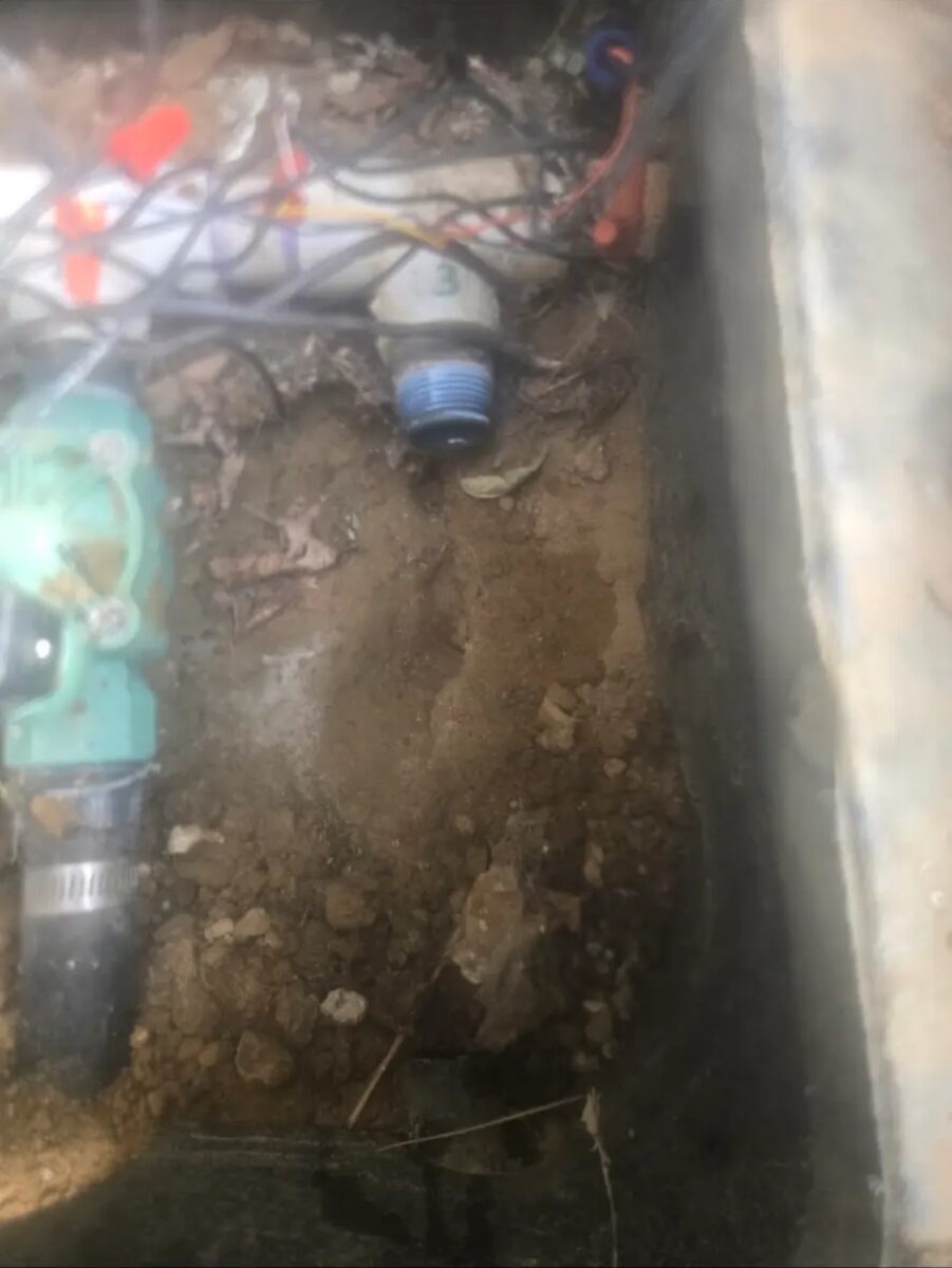 Digging out a valve box to trace a failing zone back to its manifold connection.