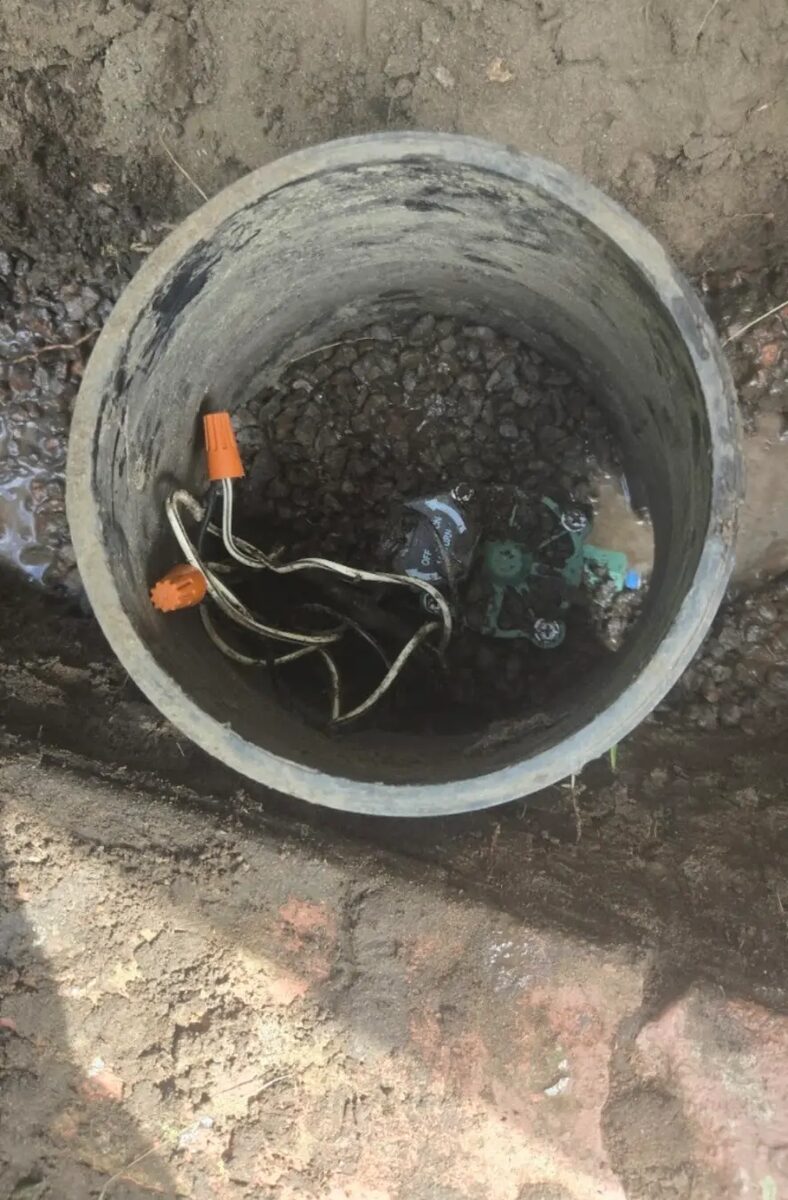 Valve serviced inside a deep concrete sleeve and drained back to gravel.